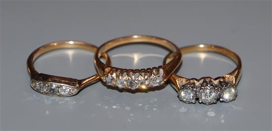 Three assorted early 20th century and later 18ct and diamond set rings, including five stone and illusion set.